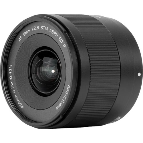 Czarny obiektyw z widocznymi napisami: "AF 9mm 1:2.8 STM ASPH ED IF" oraz "Ø58mm 0.13m/0.43ft APS-C Frame". Obiektyw ma gładką powierzchnię z wyraźnym pierścieniem do regulacji.