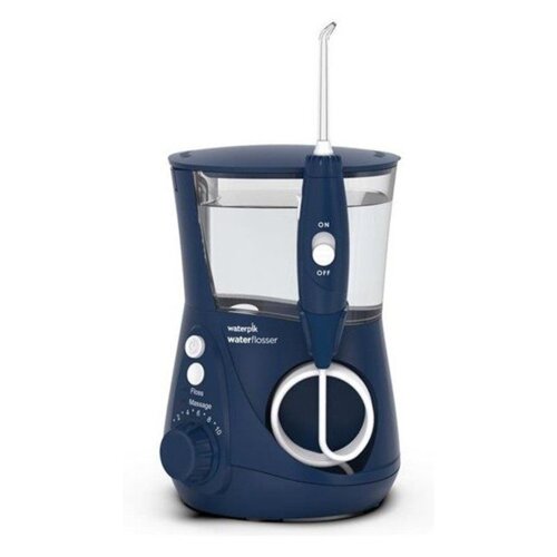 Granatowy irygator stacjonarny z przezroczystym zbiornikiem na wodę, wyposażony w uchwyt z przyciskami "ON" i "OFF". Na urządzeniu widoczne są napisy: "waterpik" oraz "waterflosser", a także pokrętło z numeracją od 1 do 10 i przyciski "Floss" oraz "Massag