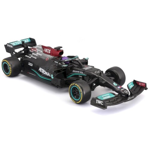 Zdalnie sterowany model samochodu wyścigowego w kolorze czarnym z turkusowymi i czerwonymi akcentami, z widocznymi logotypami "PETRONAS", "AMG", "IWC" oraz "INEOS". Opony mają żółte napisy "P ZERO", a na karoserii znajdują się różne detale i oznaczenia sponsorów.