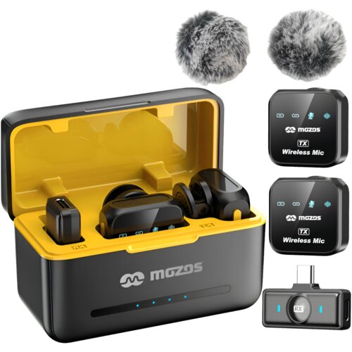 Na zdjęciu znajduje się system bezprzewodowy MOZOS MX3-Dual, w skład którego wchodzą dwa mikrofony z logo "mozos" oraz odbiornik, umieszczone w otwartym etui z żółtym wnętrzem. Obok etui widoczne są dwa szare osłony przeciwwietrzne.