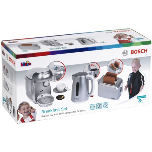 Pudełko z zabawkowym zestawem śniadaniowym marki Bosch, zawierające ilustracje ekspresu do kawy, czajnika i tostera, z widocznymi napisami "Breakfast Set" oraz "Replica toy with child-compatible functions". Na opakowaniu znajdują się także logotypy Bosch i Klein oraz oznaczenie wiekowe "3+".
