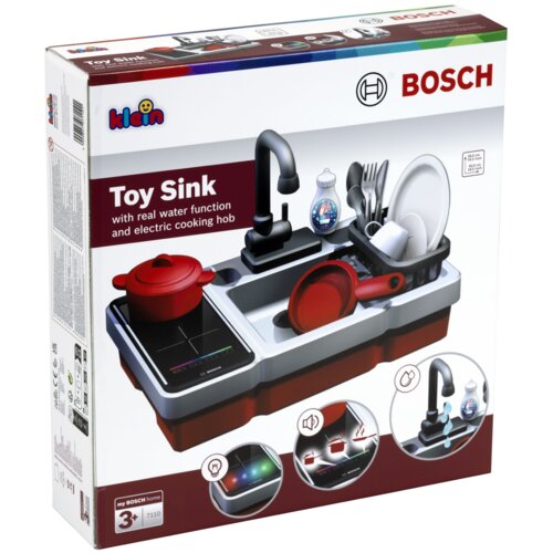 Pudełko przedstawia zabawkowy zestaw kuchenny z umywalką, garnkiem, patelnią i suszarką na naczynia, z logo "klein" i "BOSCH". Na opakowaniu widnieje napis: "Toy Sink with real water function and electric cooking hob", a także oznaczenie wiekowe "3+" i numer "7110".