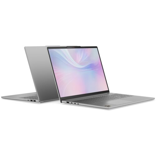 Na zdjęciu widoczne są dwa laptopy w kolorze srebrnym, ustawione w taki sposób, że jeden jest otwarty, a drugi zamknięty. Ekran otwartego laptopa wyświetla abstrakcyjny, kolorowy wzór w odcieniach różu i fioletu.