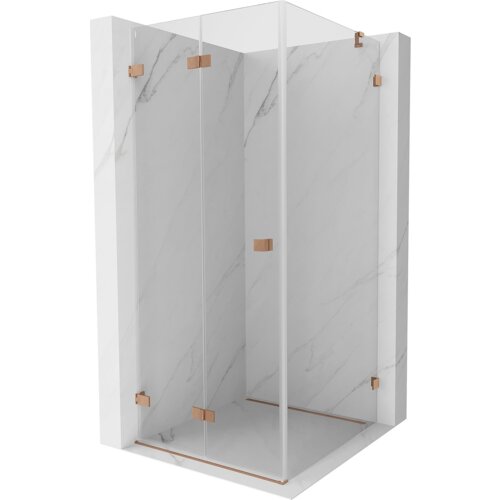 Na zdjęciu znajduje się składana kabina prysznicowa o wymiarach 70 x 70 cm z transparentnym szkłem i elementami w kolorze miedzi szczotkowanej. Kabina jest umieszczona na tle ścian z jasnego marmuru.