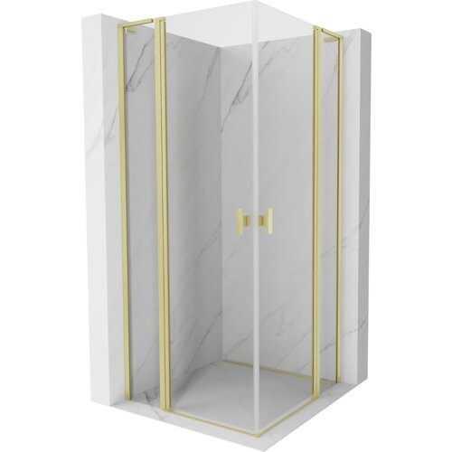Kabina prysznicowa o wymiarach 90 x 90 cm z transparentnym szkłem i złotymi, szczotkowanymi elementami, umieszczona w narożniku z marmurowymi ścianami. Drzwi kabiny mają złote uchwyty i złote ramy.