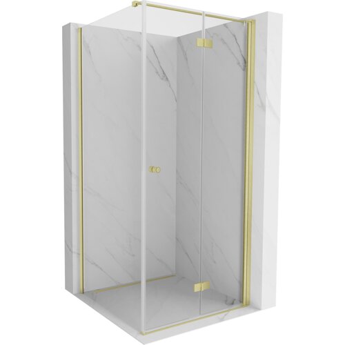 Na zdjęciu znajduje się składana kabina prysznicowa o wymiarach 90 x 90 cm z transparentnym szkłem i złotymi, szczotkowanymi elementami. Kabina ma elegancki, nowoczesny design z marmurowym wzorem na ścianach.