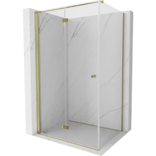 Na zdjęciu znajduje się składana kabina prysznicowa o wymiarach 70 x 80 cm z transparentnym szkłem i złotymi elementami wykończenia. Kabina jest umieszczona na tle ścian z jasnego marmuru z delikatnym wzorem.