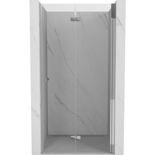 Na zdjęciu widoczne są składane drzwi prysznicowe o transparentnej powierzchni z chromowanymi elementami, zamontowane w marmurowej wnęce. Drzwi mają prosty, nowoczesny design z delikatnym uchwytem.