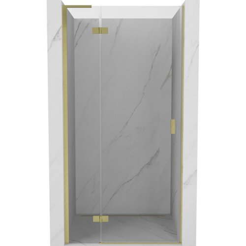 Przeszklone drzwi prysznicowe z przezroczystego szkła, osadzone w złotych, szczotkowanych ramach, zamontowane w marmurowej wnęce. Drzwi mają prosty, nowoczesny design z widocznymi zawiasami i uchwytem.