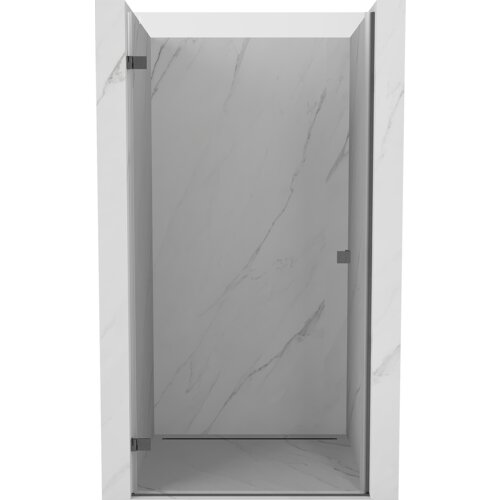 Drzwi prysznicowe uchylne w kolorze gun gray szczotkowanym, z przezroczystym szkłem, zamontowane w marmurowej wnęce. Produkt ma minimalistyczny design z widocznymi zawiasami.