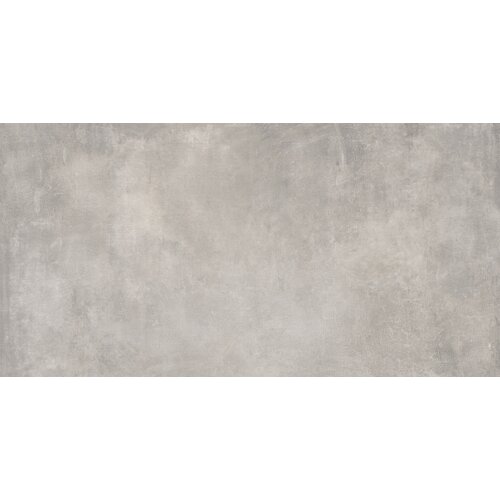 Na zdjęciu widoczna jest płytka o matowej powierzchni w odcieniach szarości, z delikatnym wzorem przypominającym beton. Brak widocznych napisów lub logo.