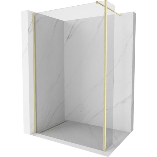 Na zdjęciu znajduje się ścianka prysznicowa typu walk-in o wymiarach 130 x 40 cm, wykonana z transparentnego szkła z elementami w kolorze złotym szczotkowanym. Ścianka jest umieszczona w narożniku wyłożonym płytkami imitującymi marmur.