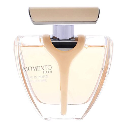 Przezroczysty flakon perfum o pojemności 100 ml z beżowym korkiem, na którym widnieje napis "MOMENTO FLEUR EAU DE PARFUM POUR FEMME". Wnętrze flakonu wypełnione jest jasnym płynem.