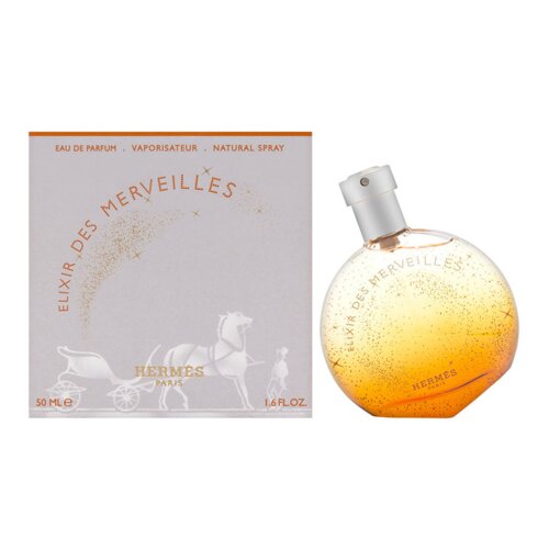 Na zdjęciu widoczna jest butelka perfum o okrągłym kształcie z pomarańczowym płynem oraz opakowanie z napisem "ELIXIR DES MERVEILLES" i grafiką konia z wozem. Na opakowaniu znajdują się również napisy "EAU DE PARFUM", "VAPORISATEUR", "NATURAL SPRAY", "50 ML E", "1.6 FL OZ" oraz "HERMES PARIS".