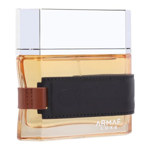 Flakon perfum o pojemności 100 ml z przezroczystego szkła z bursztynowym płynem, ozdobiony czarnym paskiem z brązowym akcentem. Na dole widoczny jest napis "ARMAF LUXE".