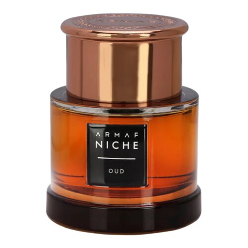 Butelka perfum o cylindrycznym kształcie z miedzianym korkiem, na której widnieje czarny prostokąt z białym napisem "ARMAF NICHE OUD". Szkło butelki jest przezroczyste, ukazując bursztynowy płyn wewnątrz.