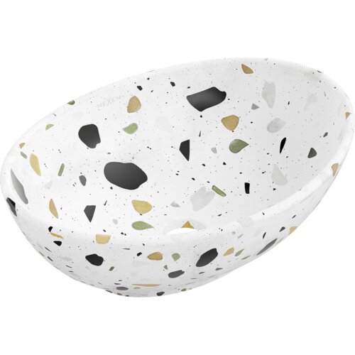 Biała umywalka nablatowa o owalnym kształcie z wzorem w kolorowe plamki, w tym czarne, zielone i złote, wykonana z materiału przypominającego terrazo. Na powierzchni widoczne jest logo "Mexen".