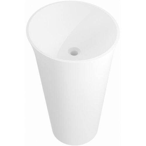 Na zdjęciu widoczna jest biała, matowa umywalka wolnostojąca o cylindrycznym kształcie, wykonana z konglomeratu. Umywalka ma gładką powierzchnię i centralnie umieszczony otwór odpływowy.