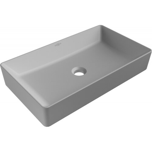 Prostokątna, jasnoszara matowa umywalka nablatowa z centralnym otworem odpływowym, na której widoczne jest logo "Mexen". Umywalka ma gładkie, zaokrąglone krawędzie i minimalistyczny design.