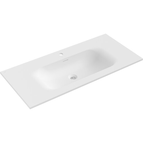 Biała matowa umywalka wpuszczana w blat o wymiarach 101 x 46,5 cm z otworem na baterię i odpływem. Produkt ma prostokątny kształt z zaokrąglonymi krawędziami wewnętrznymi.