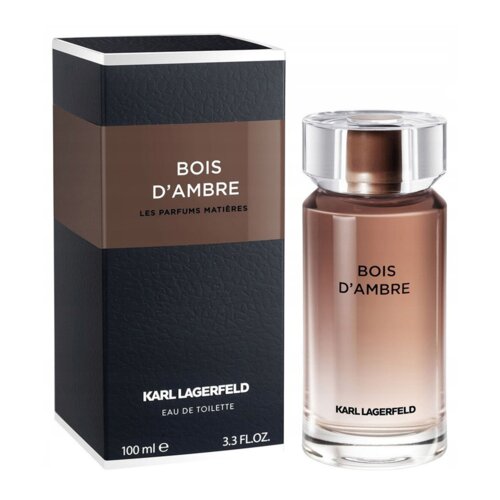 Na zdjęciu widoczna jest butelka perfum oraz pudełko z napisem "BOIS D'AMBRE LES PARFUMS MATIÈRES". Na dole pudełka znajduje się tekst "KARL LAGERFELD EAU DE TOILETTE 100 ml e 3.3 FL.OZ".
