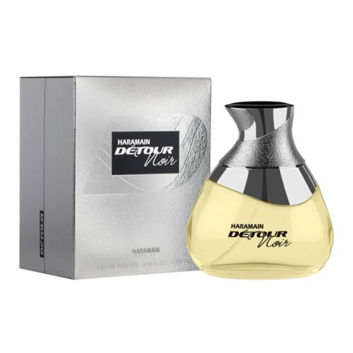 Na zdjęciu widoczna jest butelka perfum o nazwie "Haramain Détour Noir" oraz srebrne opakowanie z tym samym napisem. Na opakowaniu znajduje się dodatkowy tekst: "EAU DE PARFUM 3.33 FL OZ 100 ML".