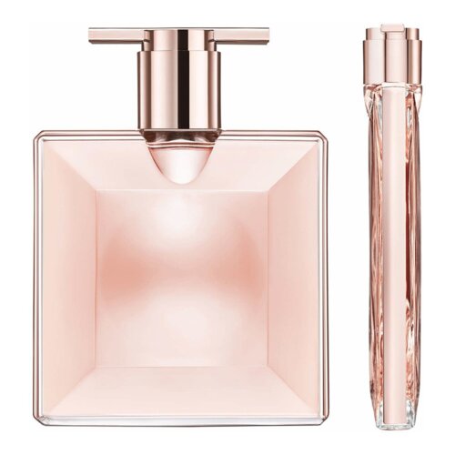 Kwadratowy flakon perfum w kolorze różowego złota z metalicznym korkiem oraz smukły, cylindryczny pojemnik w podobnym odcieniu. Oba elementy mają elegancki, minimalistyczny design.