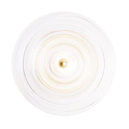 Zdjęcie przedstawia złoty, okrągły kinkiet ścienny z przezroczystym kloszem, widziany z góry. Klosz ma dekoracyjny wzór i centralnie umieszczony złoty element.